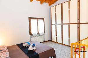 a room with a bed with two towels on it at In Love 01 in Montichiari