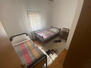 a small room with two beds and a window at Lav Apartments in Bihać