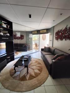 a living room with a couch and a coffee table at Thermas Paradise in Rio Quente