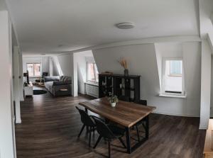 a living room with a wooden table and chairs at B&B Ferienwohnung mit bester Aussicht/Lage in Wangen im Allgäu