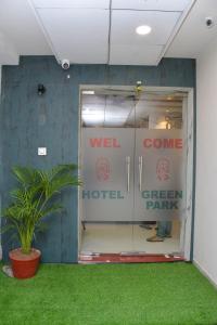 a room with a door to a hotel with a plant at Hotel Green Park in Gandhinagar