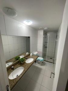 uma casa de banho com 3 lavatórios e um WC em Quartos - Cíntia em Fortaleza