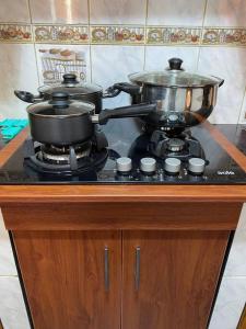 a stove with two pots and pans on top of it at Casa Hospedaje Cajamarca in Cajamarca