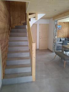 a staircase in a house with a living room at Chalet des Lys - tout confort - 12 personnes in Valloire