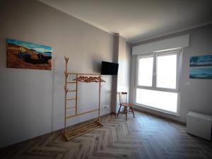 a living room with a ladder and a window at The House of the Waves in Brindisi