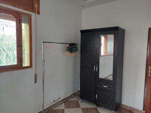 a room with a black cabinet and a window at Comfort house 