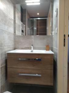 a bathroom with a sink and a mirror at Chalet des Lys - tout confort - 12 personnes in Valloire