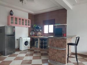 a kitchen with a refrigerator and a washing machine at Comfort house 