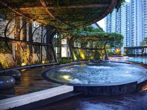 a fountain in the middle of a city with buildings at M Centura Sentul 2 bedrooms with pool in Kuala Lumpur