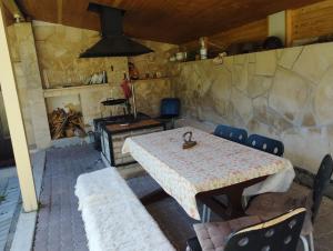 a table and chairs in a room with a fireplace at Bystra 14 in Brezno