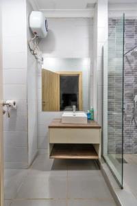 a bathroom with a sink and a shower at W16 Water Front Apartments in Lekki