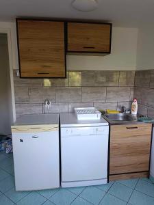 a kitchen with a white refrigerator and a sink at Odrodzenia 7 in Toruń