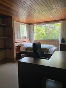 a room with two beds and a desk and a window at Santuário da Chapad a dos Veadeiros in Alto Paraíso de Goiás