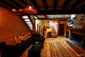 a living room with a couch and a fireplace at Camino de Hierro in Bermellar