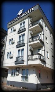 a large white building with a sign on it at PUSULA MOTEL in Akçatepe