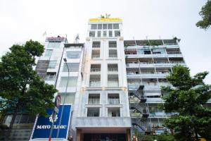 a white building with a sign on top of it at Thiên Tài Hotel in Ho Chi Minh City