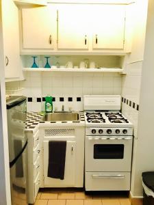 cocina con electrodomésticos blancos y fregadero en Stylish Montreal Apartment: Comfortable Stay in the Golden Square Mile, en Montreal