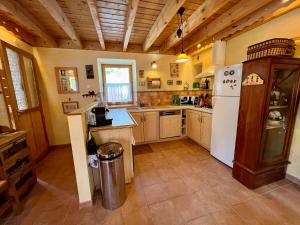 a kitchen with a white refrigerator and a counter at La Grange St. Cyprien, Venosc - Les Deux Alpes in Vénosc