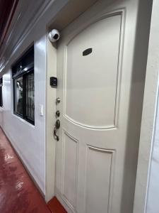 a white door in a hallway with a window at Cerevic in Cainta
