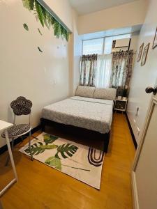 um pequeno quarto com uma cama e uma janela em Cerevic em Cainta