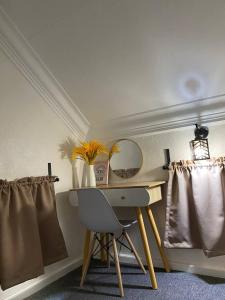 a desk with a chair and a mirror in a room at Abe.Cottage 2 in Kuala Besut