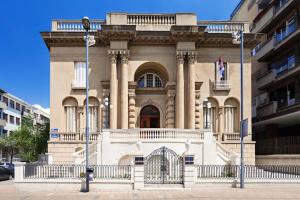 a large building with a gate in front of it at Apartman Tara in Belgrade