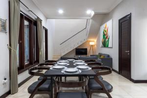 uma sala de jantar com mesa e cadeiras em SUNNYRENT. Green villa for family rest in Nusa Dua em Nusa Dua