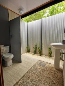 a bathroom with a toilet and a sink at DS House in Cabuya