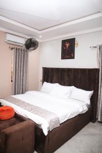 um quarto com uma cama grande e um sofá em Newly Built 2 Bedroom Tastefully Furnished House Available For Shortlet. em Lagos