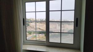 a window with a view of a city at Meadow Sweet in San Ġwann