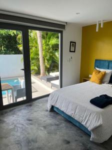 a bedroom with a bed and a view of a patio at PALM VILLAS in Sainte-Anne