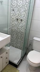 a bathroom with a shower with a toilet and a sink at Copacabana Apartment in Rio de Janeiro