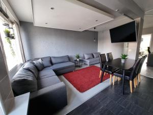 a living room with a couch and a table at Central Gem with Sauna - Big two-room apartment FREE PARKING in Tampere