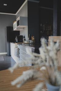 a kitchen with a table and a counter top at MaxiMar Apartment With Sauna in Valga
