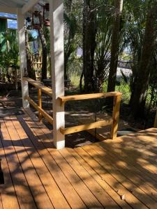 a wooden porch with two benches on a deck at 150-year-old Lincolnville cottage 3bedroom 2bath in St. Augustine