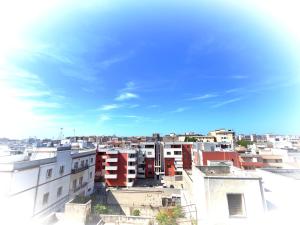 a view of a city with buildings and a blue sky at The House of the Waves in Brindisi