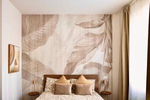 a bedroom with a bed with a large painting on the wall at Apartment Vitale in Bologna