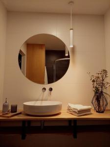 a bathroom with a sink and a mirror at Domki Miłe Chwile in Lubiatowo