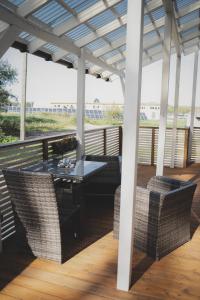 patio ze stołem i krzesłami pod pergolą w obiekcie MaxiMar Apartment With Sauna w mieście Valga
