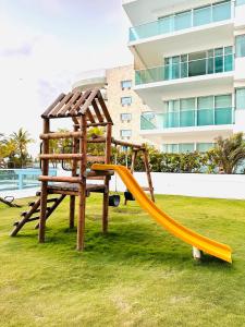 a wooden playground with a slide in a yard at Apartamento Delux Morros-Tolusa in Cartagena de Indias