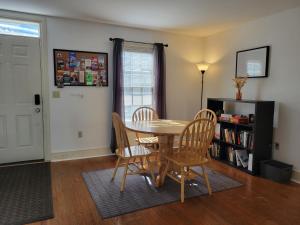 a dining room with a table and chairs and a book shelf at The Grand BnB in Harrisburg