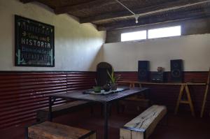 a room with a table and benches and a window at Casamora in Belén
