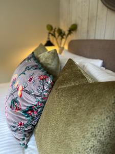 a pillow sitting on top of a bed at Luxury Cottage in Tregarth, Bethesda, Snowdonia in Tregarth