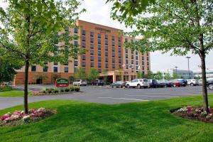 a hotel building with cars parked in a parking lot at Courtyard by Marriott Boston Billerica Bedford in Billerica