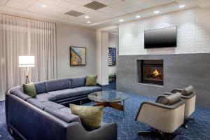 a living room with a couch and a fireplace at Courtyard by Marriott Boston Billerica Bedford in Billerica