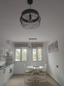 a kitchen with a table and chairs and a chandelier at Apartamento Buen Recuerdo in Camarena de la Sierra