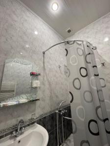 a bathroom with a sink and a shower at Najaryan's Family Guest House in Vagharshapat
