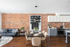 a kitchen and living room with a table and chairs at Les Lofts du Plateau in Montreal
