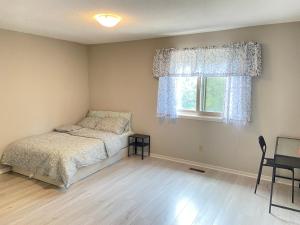 a bedroom with a bed and a window at 41 Huntsmill Blvd in Toronto