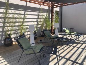 a group of chairs sitting on a deck at Le 7 in Vieille-Toulouse